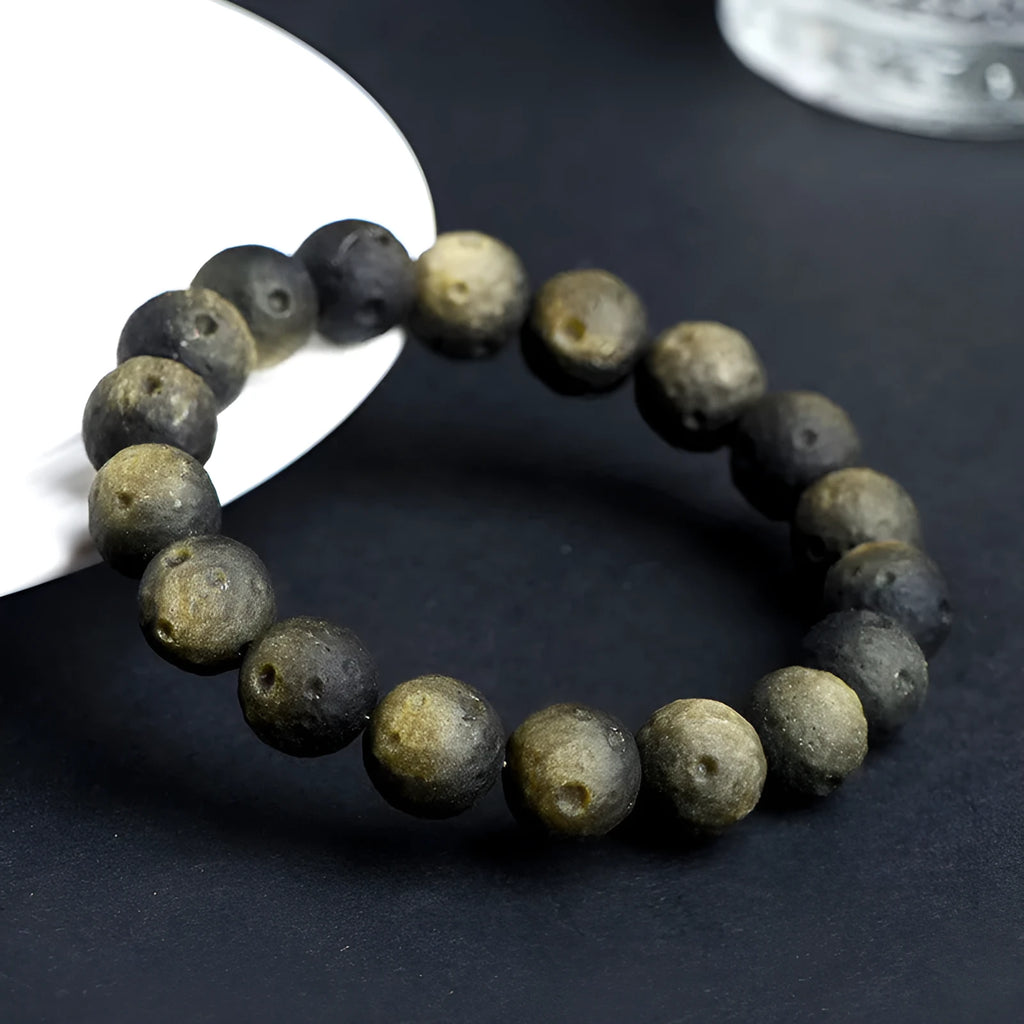Natural obsidian crater ball bracelet with grinding finish in silver or golden meteorite colours with various bead sizes