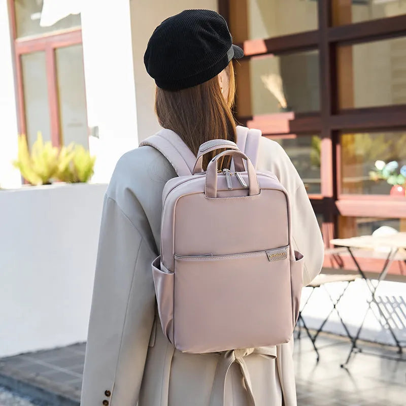 Large women's travel backpack with multiple compartments in apricot colour
