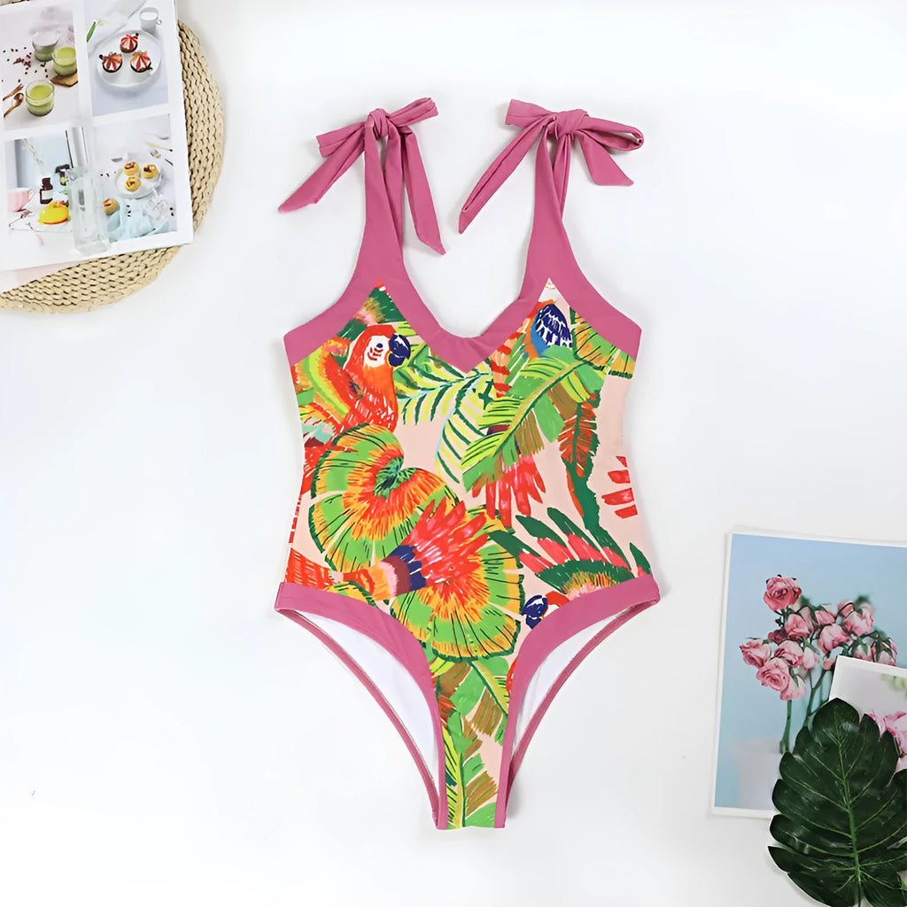 Pink floral print women's V-neck one-piece swimsuit with a thin skirt.