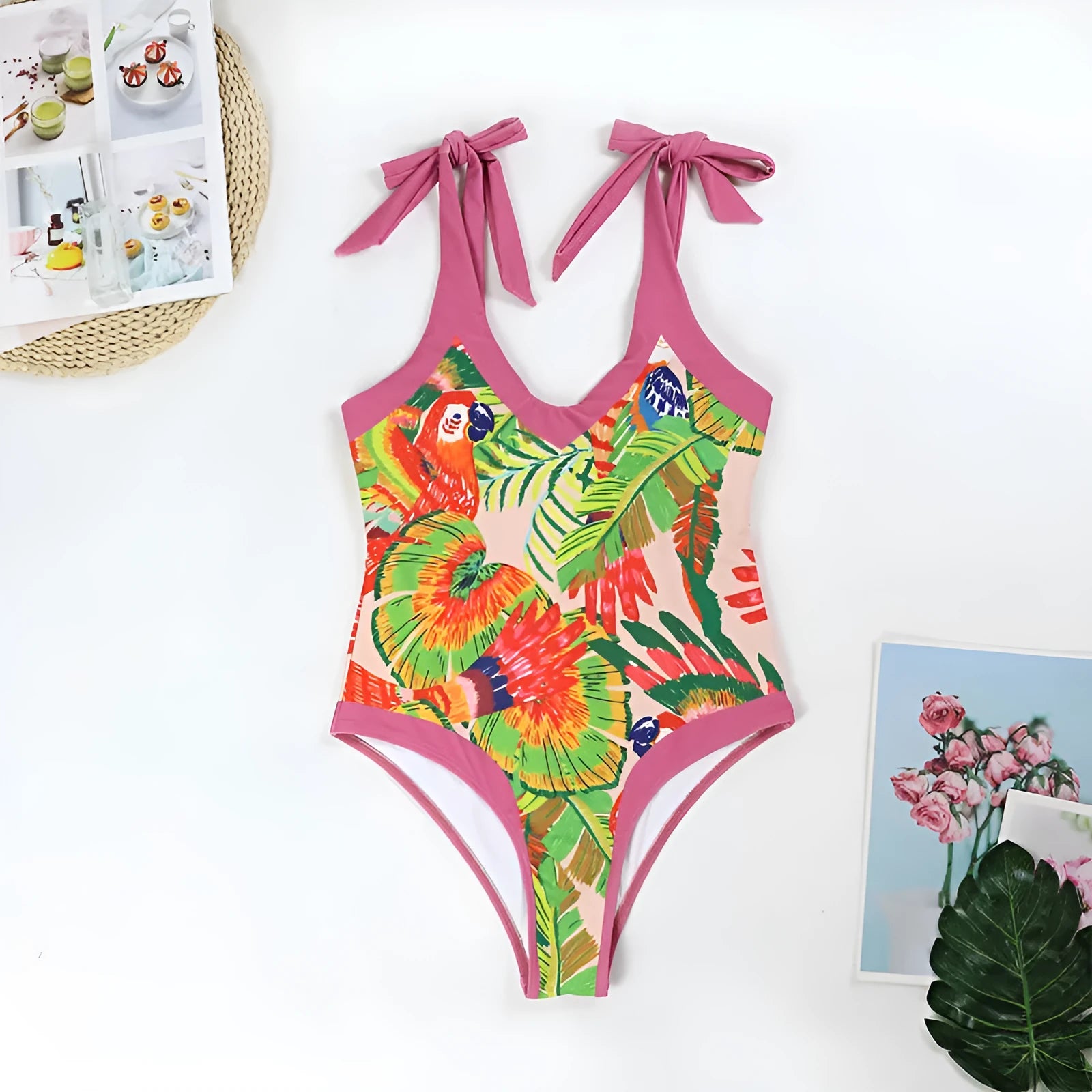 Pink floral print women's V-neck one-piece swimsuit with a thin skirt.