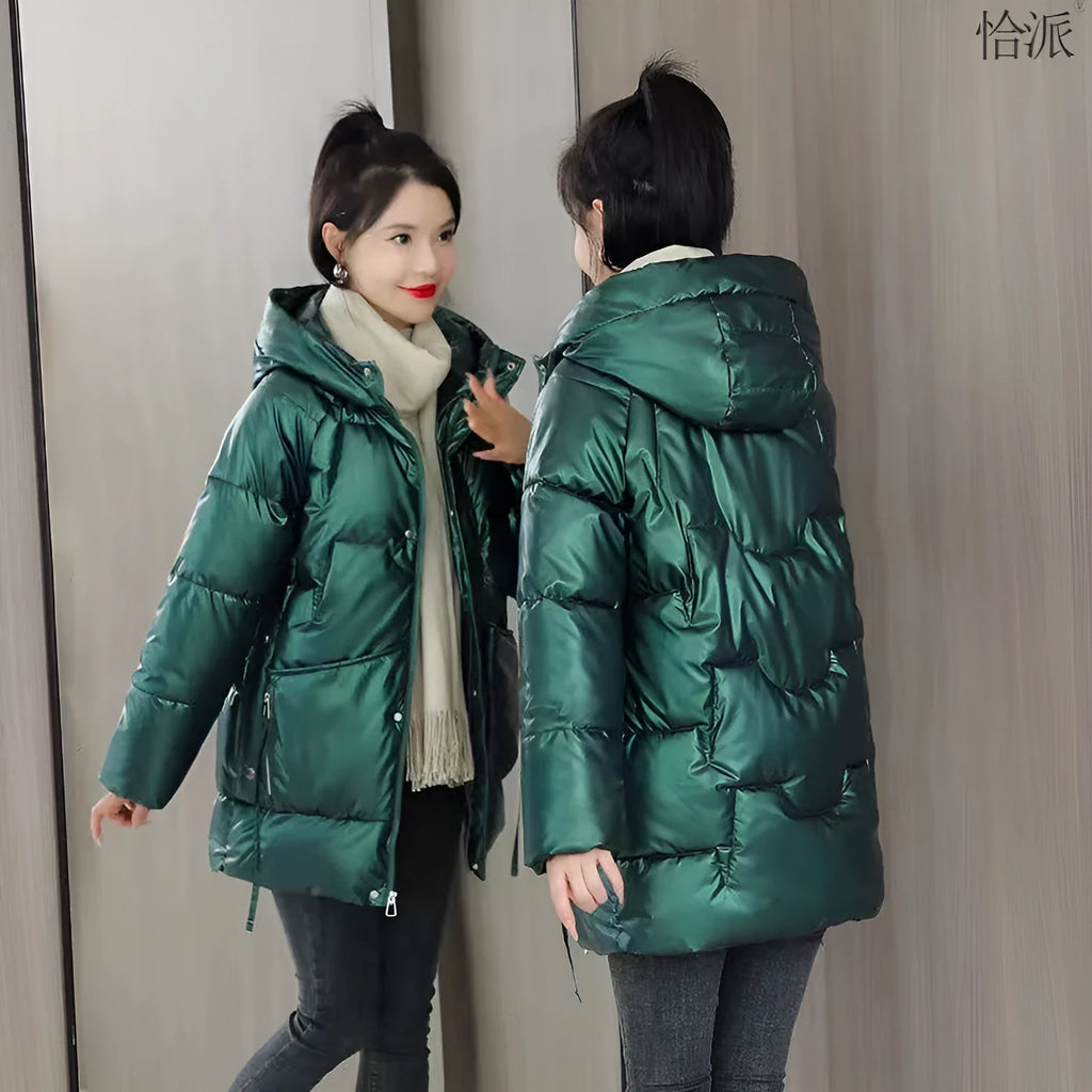 Women's green thick loose fit hooded winter jacket with long sleeves on a hanger.