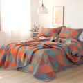 Cotton gauze floral blanket and two pillowcases set laid on a bed, showing plants and flowers pattern.