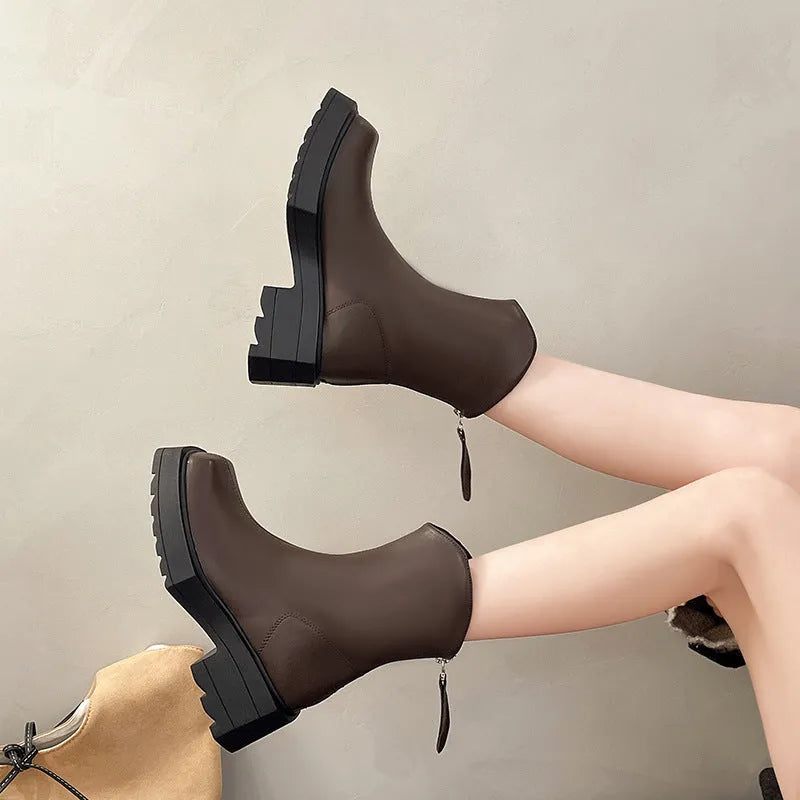Women's black platform Martin boots with square toe, chunky sole, back zipper, and block heel.