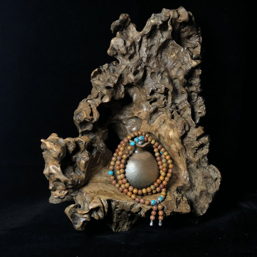 Stone bracelet with 108 geometric beads showing hand-polished finish