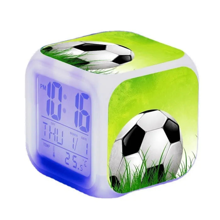 Square cartoon alarm clock with a football pattern design, showing a four-sided mute alarm for children.