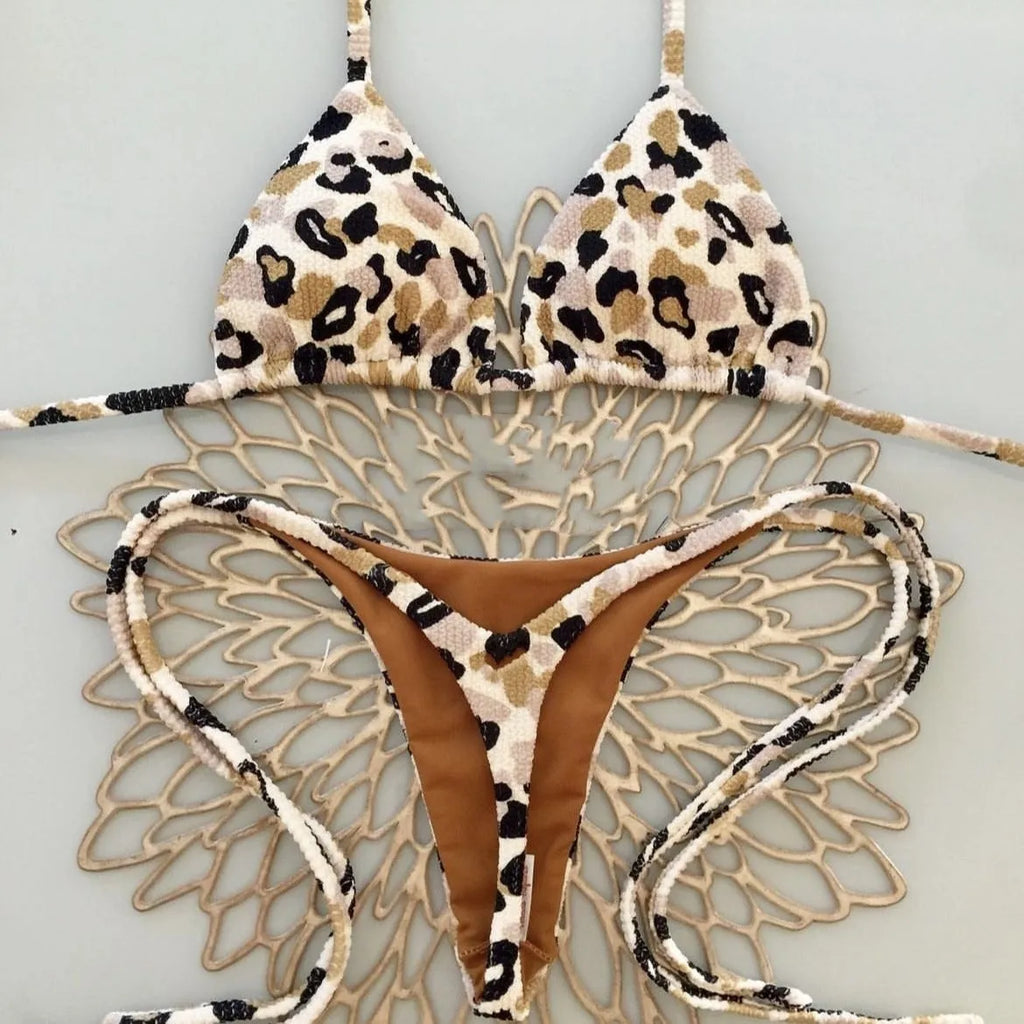 Women's printed bikini swimsuit set on a hanger, showing quick-dry fabric and cotton-lined briefs.