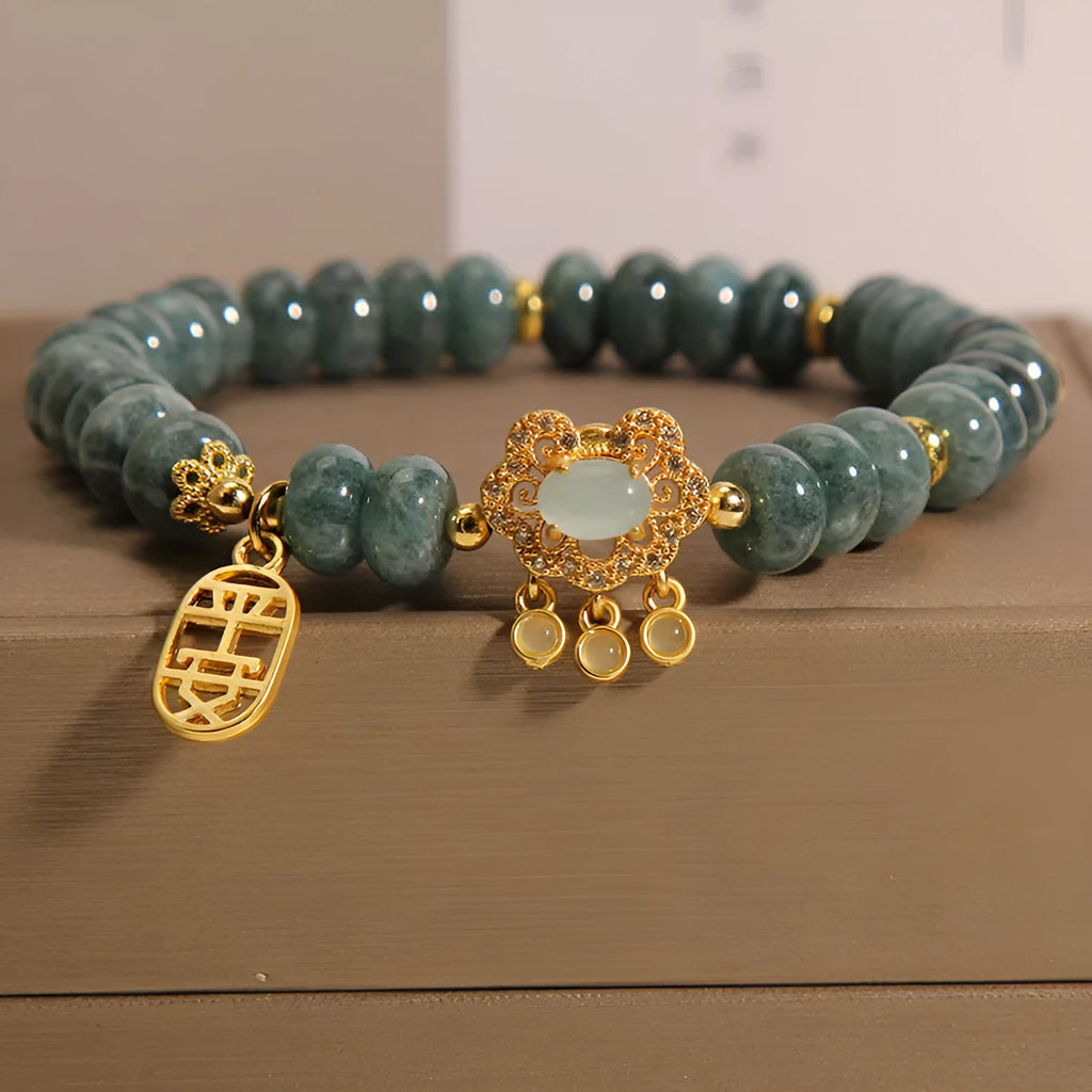 Natural emerald jade abacus bead bracelet for women with a metal safety lock closure.