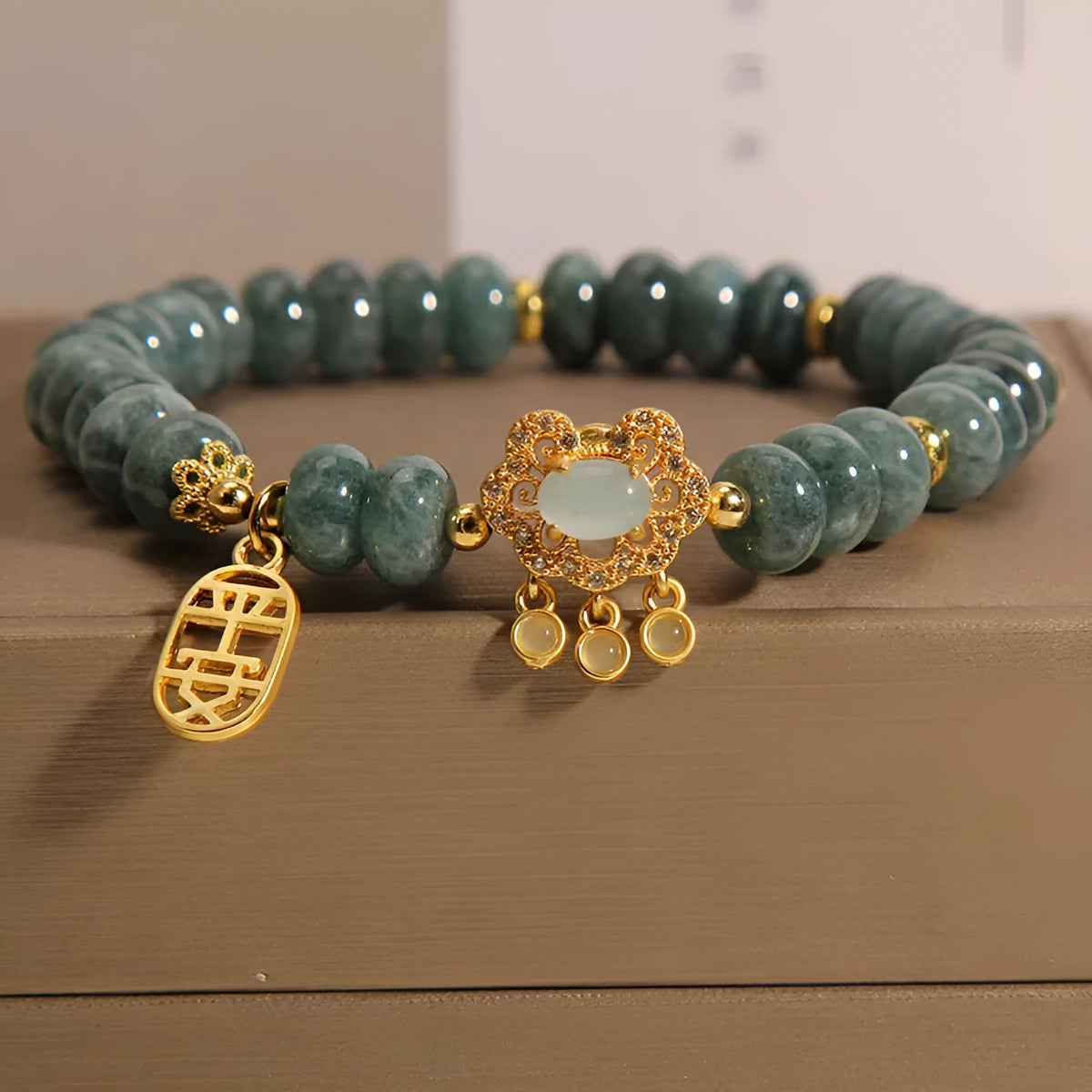 Natural emerald jade abacus bead bracelet for women with a metal safety lock closure.