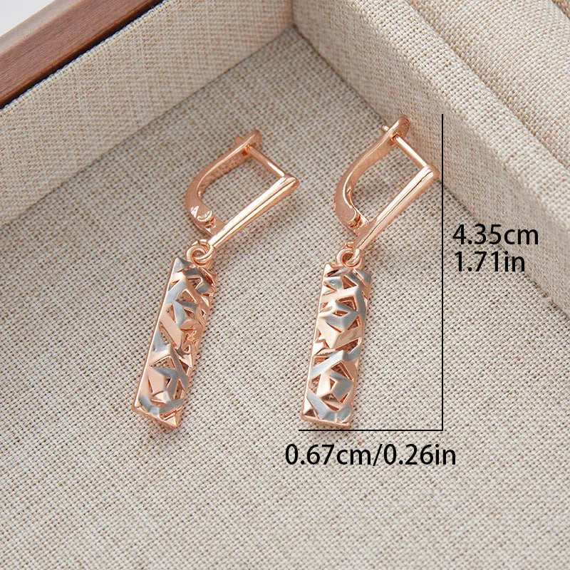 A pair of rectangular two-tone hollow stud earrings with an electroplated finish on a white background.