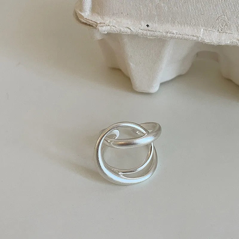 Geometric open ring with three-dimensional interlaced matte metal design and gold electroplating