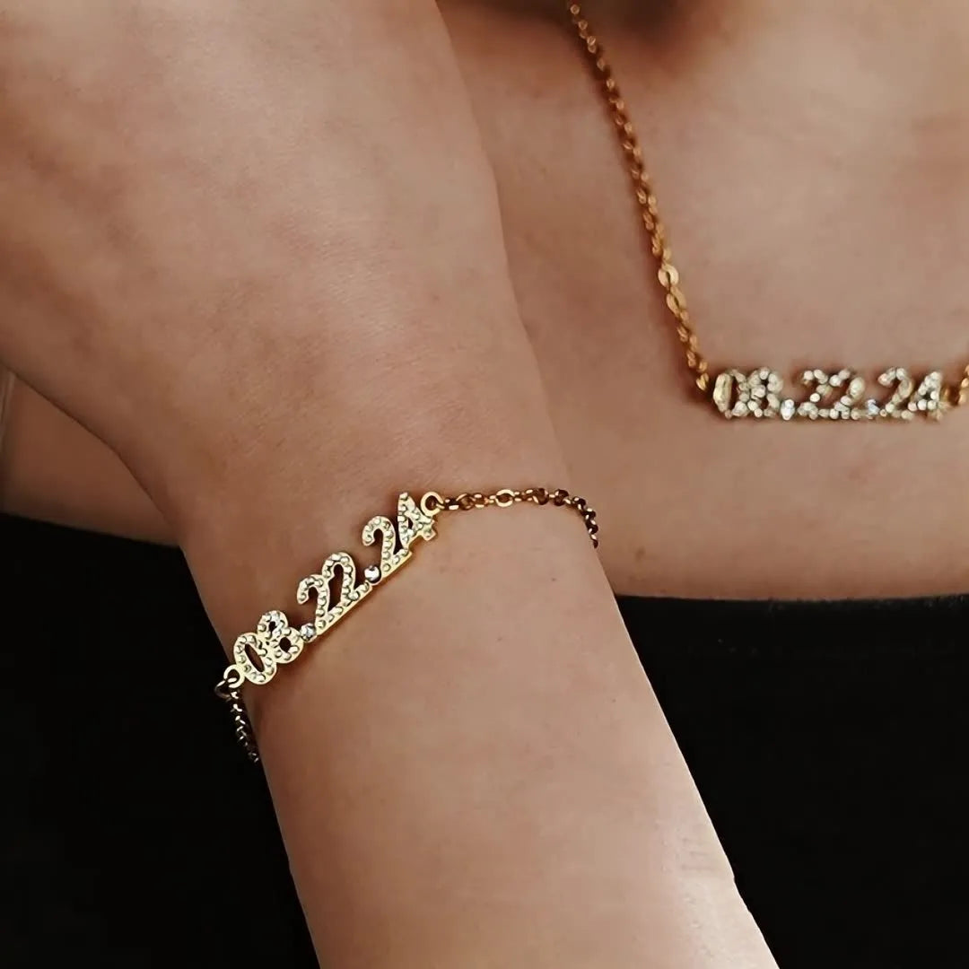 Stainless steel digital bracelet or necklace with diamond-set numbers in gold, rose gold, or steel colour.