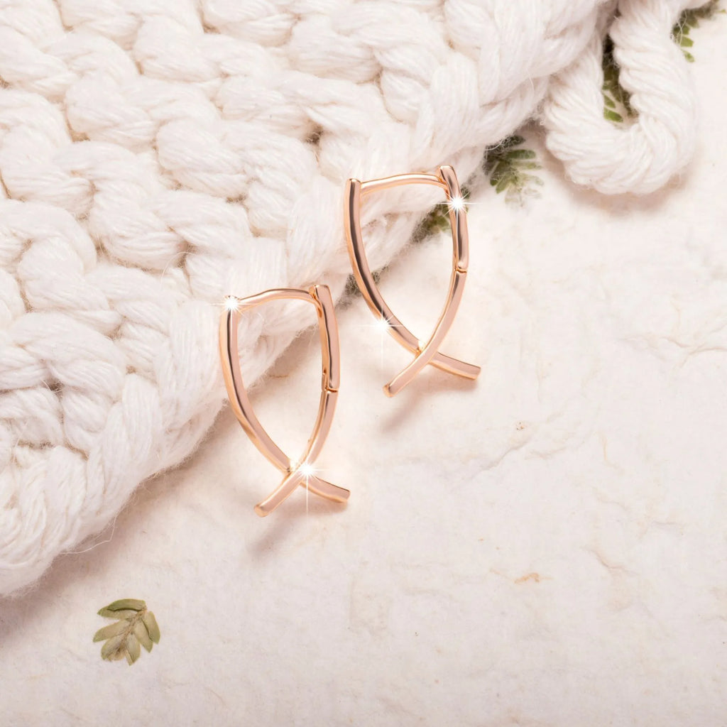 Rose gold cross shaped copper earrings with minimalist design and light luxury finish
