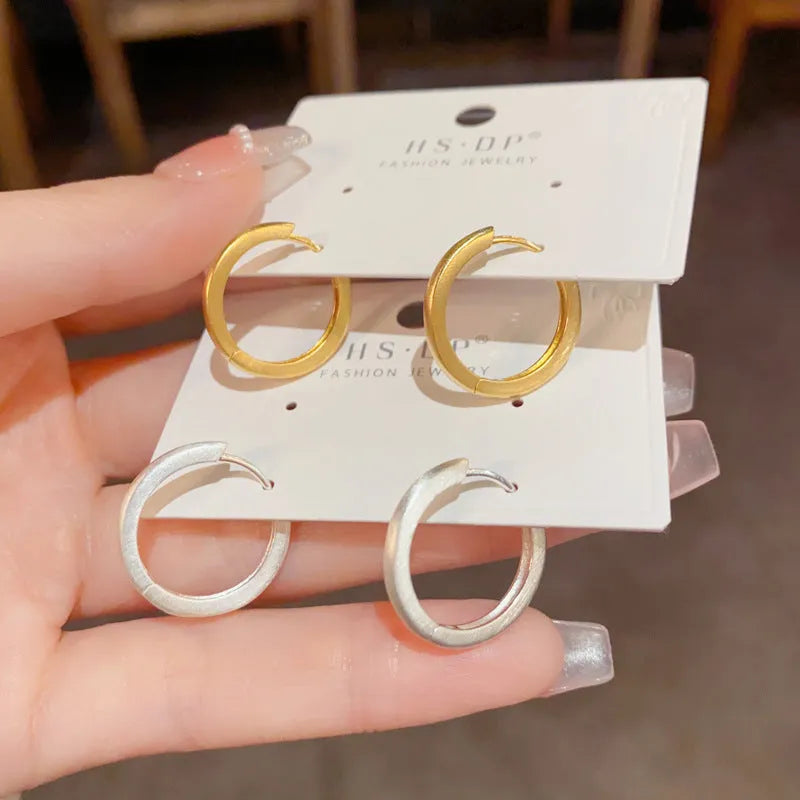 Geometric circular gold plated ear clip for women with eyelet clip mechanism