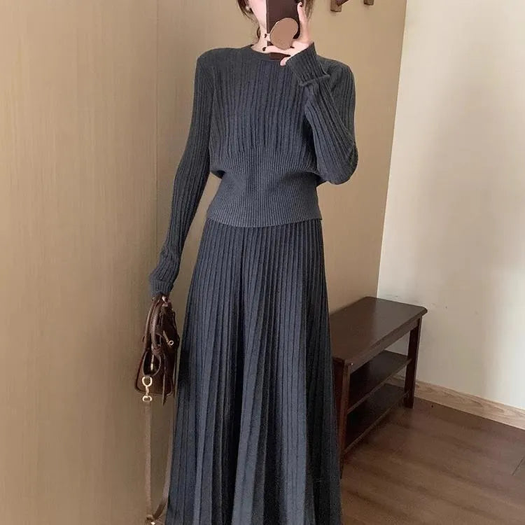 Dark grey knitted dress and skirt suit with a 3D pattern and ethnic collage stitching.