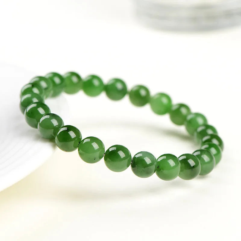 Natural Hetian jade beaded bracelet in various bead sizes on a plain background.