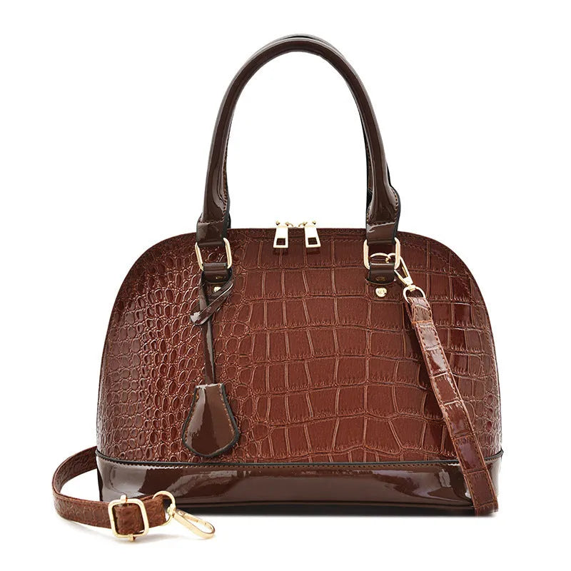 Glossy PU leather crossbody shoulder bag in shell shape with structured design
