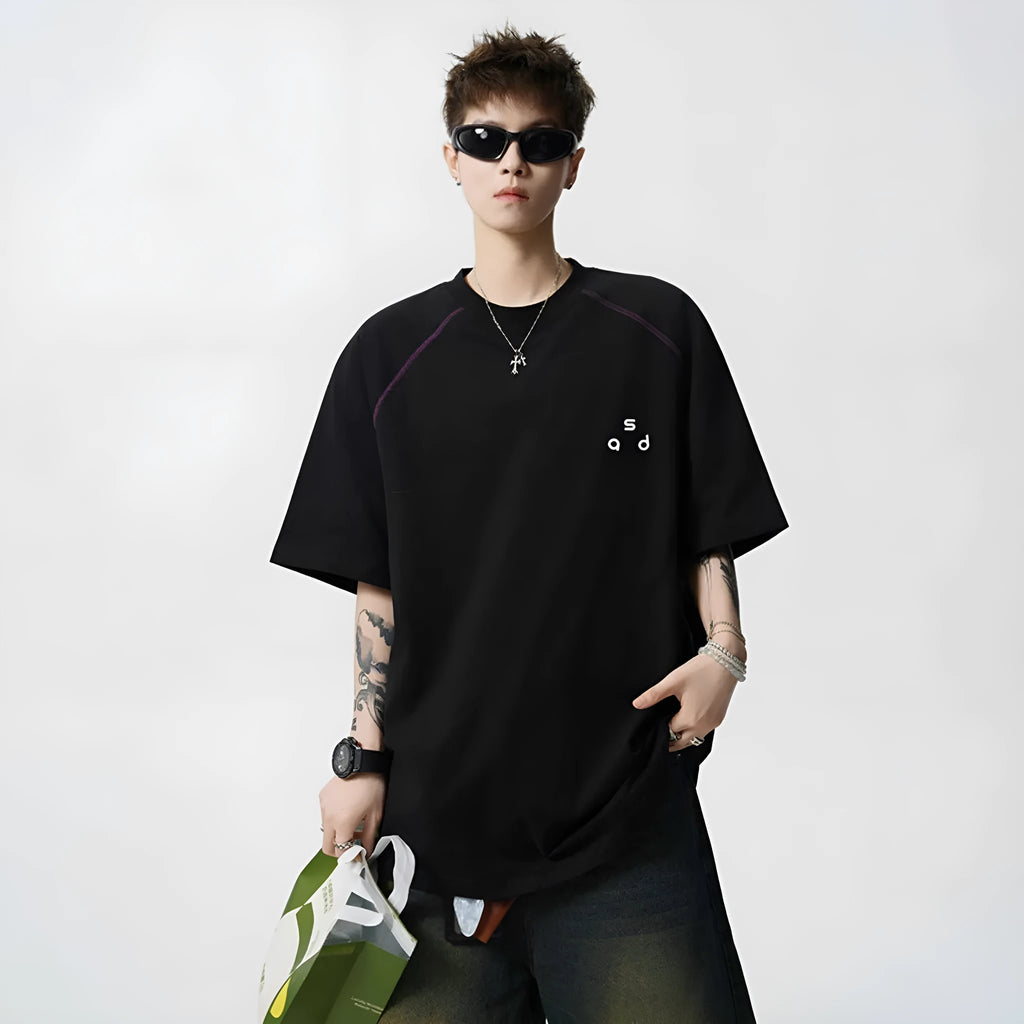 Loose-fit black cotton short-sleeve t-shirt with white letter print graphic on a mannequin.
