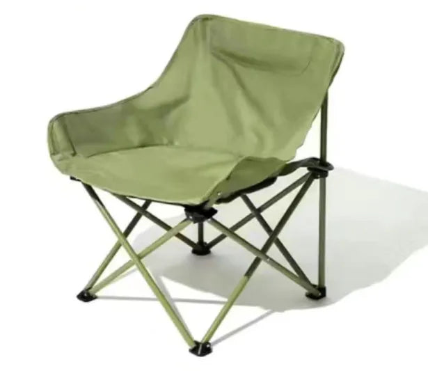 Beige folding camping chair with reclined back and steel frame on grass.