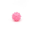 Blue spiky squeaky dog toy ball with paw print dimples measuring 2 inches in diameter