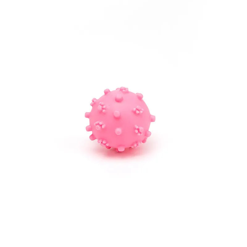 Blue spiky squeaky dog toy ball with paw print dimples measuring 2 inches in diameter