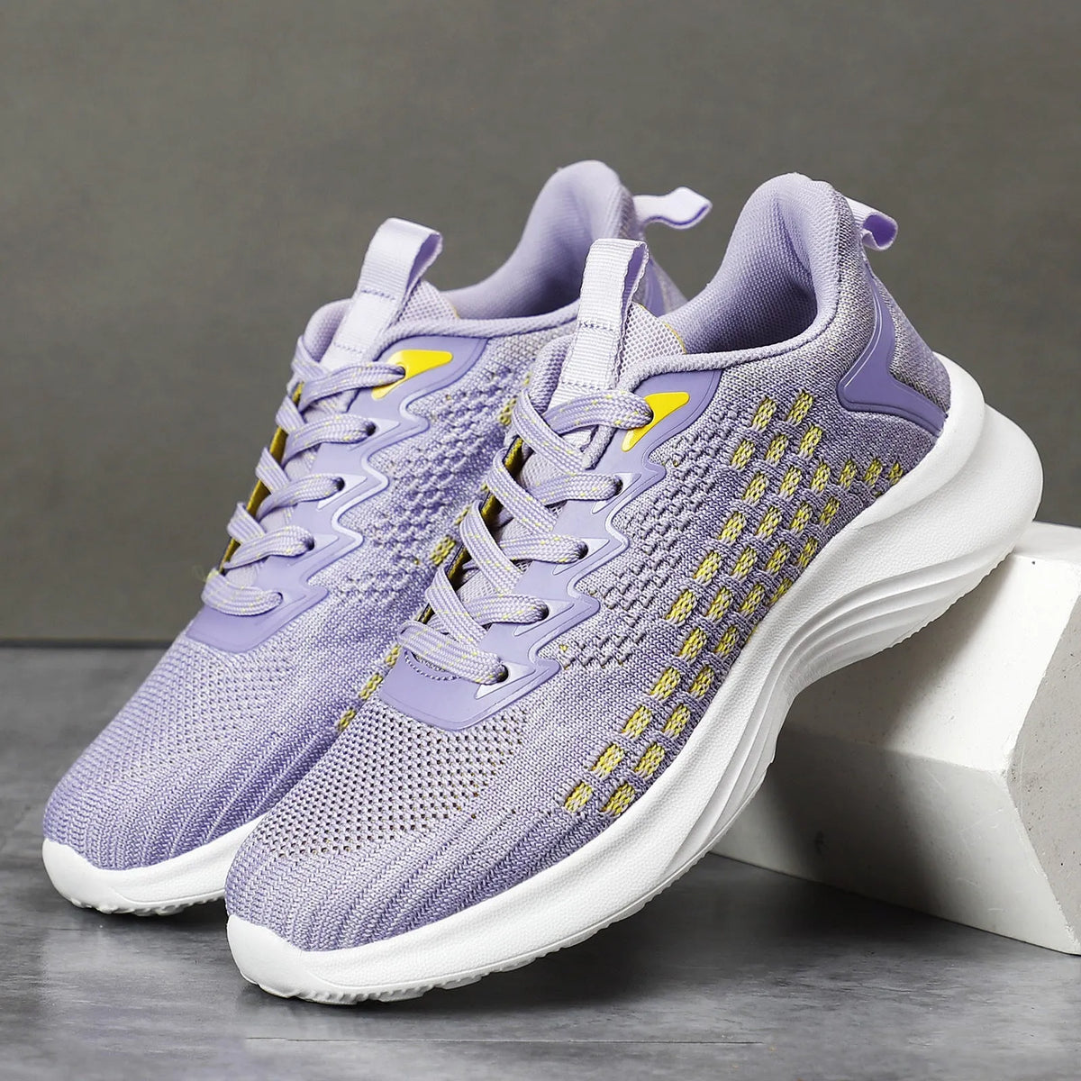 Women's lavender purple Flyknit running shoes with mesh lining and EVA sole, shown in a side view.