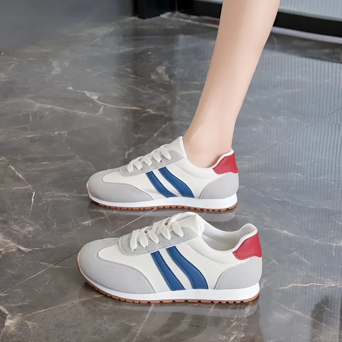 Blue and grey leisure sports shoes with Cortez stripes pattern, round toe, and flat rubber sole.