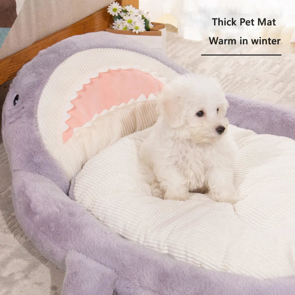 Blue shark pattern pet bed cushion for dogs or cats on a wooden floor.