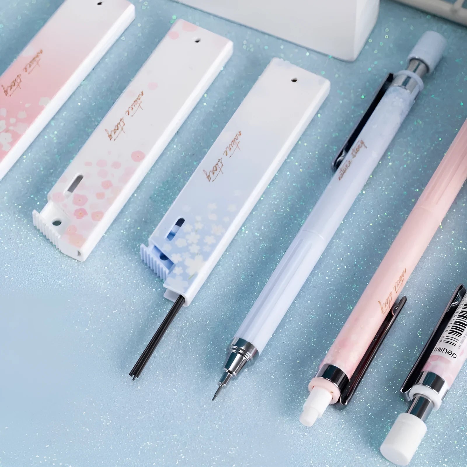 Cartoon style automatic pencil set with three pens and HB lead refills in mixed colours.