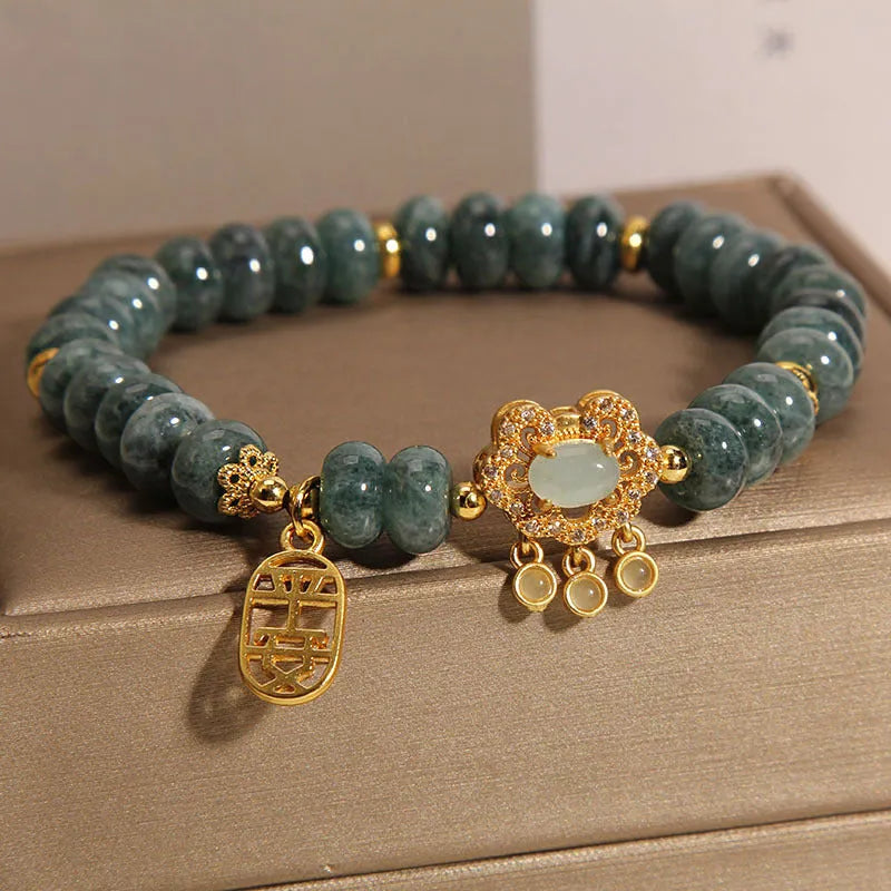 Natural emerald jade abacus bead bracelet for women with a metal safety lock closure.