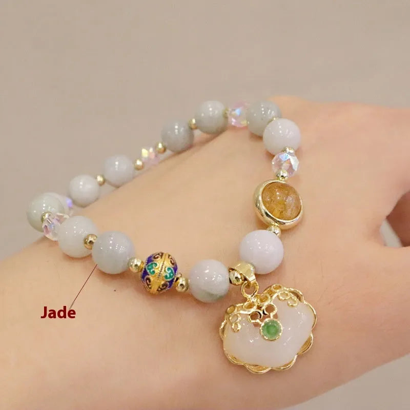Women's ethnic bracelet with geometric metal decorations and strawberry quartz or gray jade beads