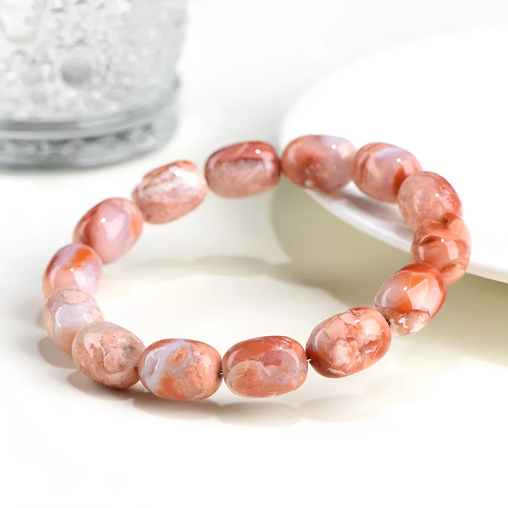 Natural cherry agate barrel bead bracelet with Ruyi elements measuring 10x14mm