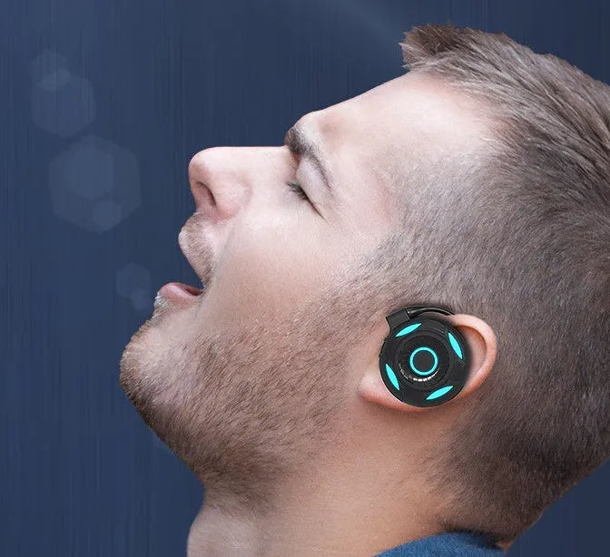 Black and white Bluetooth gaming earphones with hanging ear design showing wireless connectivity