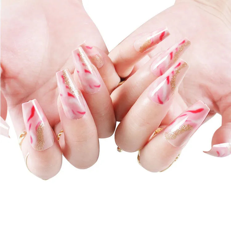 Wearable manicure set with 24 medium nails in rose, tulip, leopard print, and XINGX designs, plus glue.
