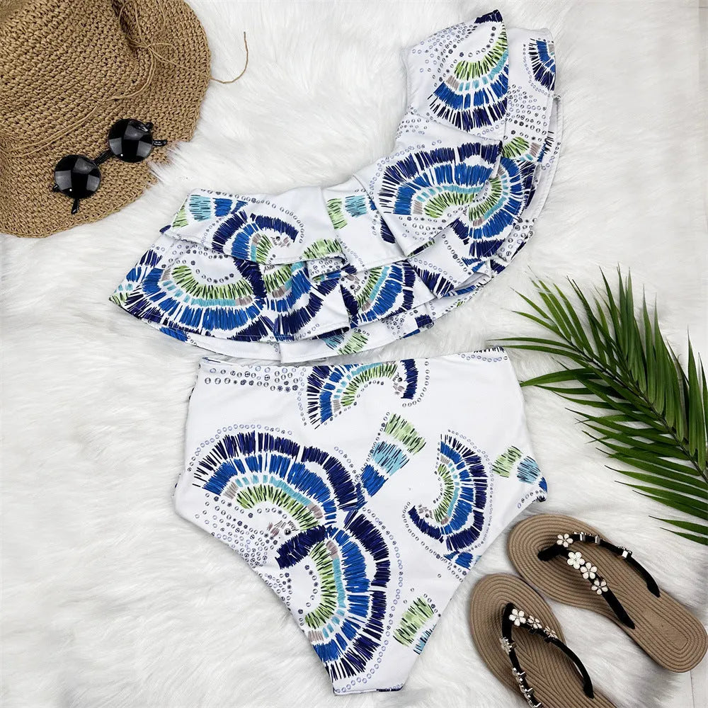 White women's one-shoulder swimsuit with large lotus leaf design and side split