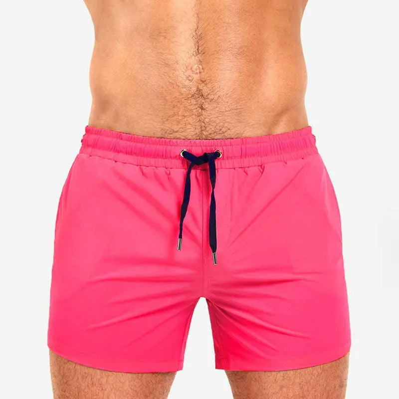 Men's solid colour polyester swimming shorts with mesh lining for sports and fitness.