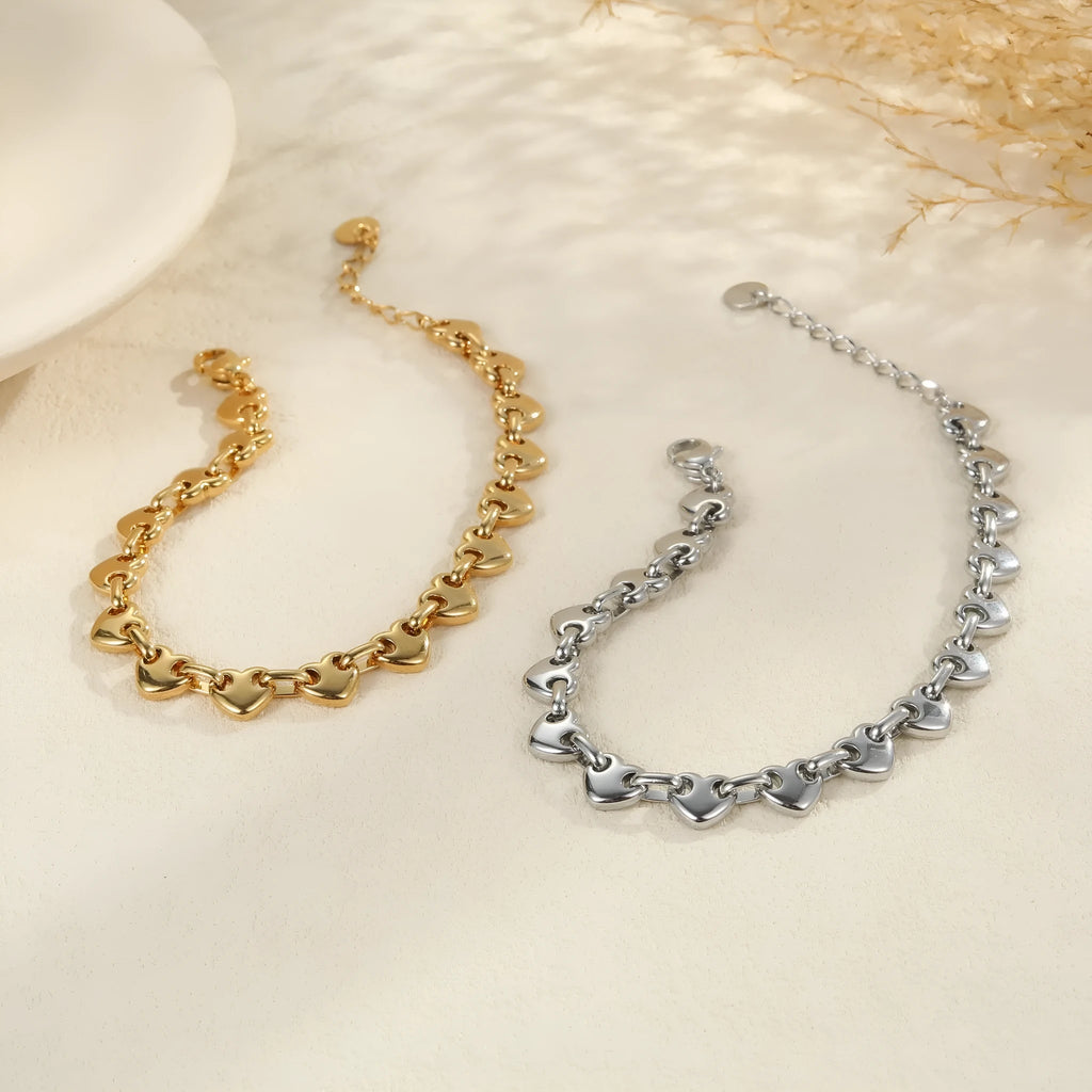 Women's hollowed-out heart bracelet in gold or steel colours with big heart and small heart size options
