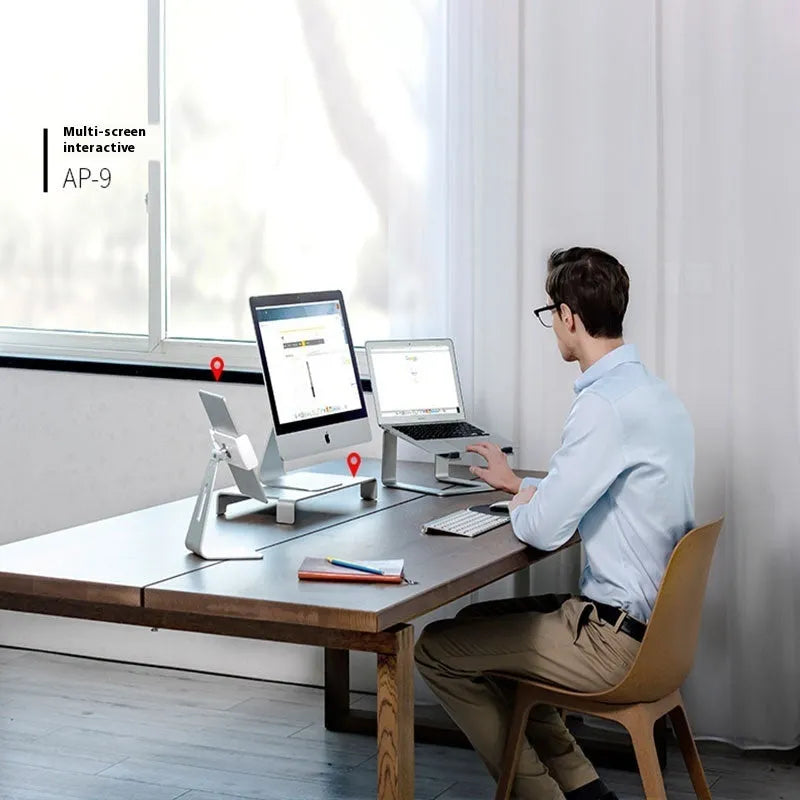 Black aluminium alloy laptop stand on a desk, showing its size and solid base plate.