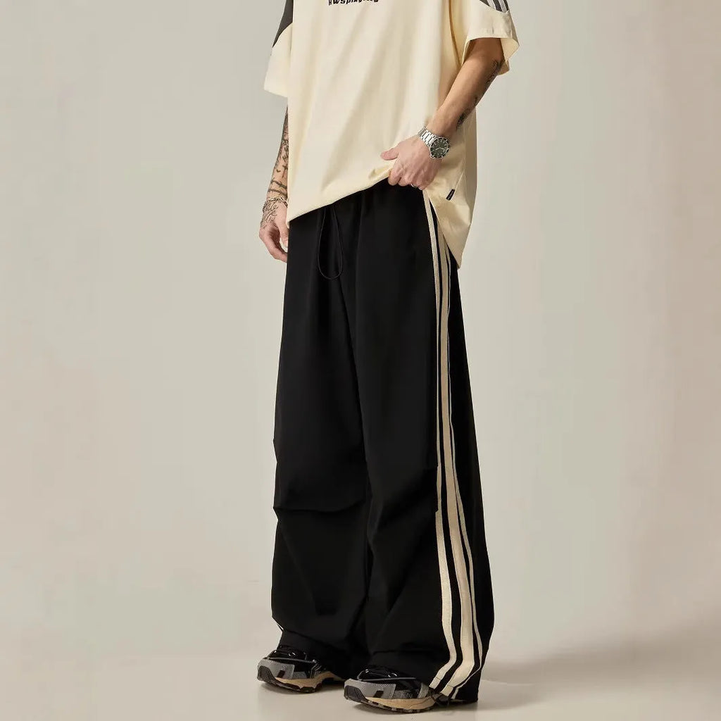 Black wide leg climbing trousers with high waist and straight leg design on hanger