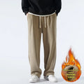Men's apricot coloured loose-fit polar fleece winter trousers with a drawstring waist, shown flat.