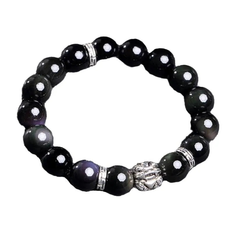 Natural obsidian bracelet with silver 999 clasp in 10mm or 12mm size on a wrist.