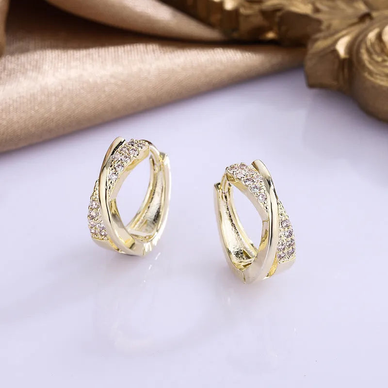 A pair of geometric drop earrings in 14K yellow gold colour, made from copper with a zircon treatment detail.