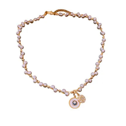 Gold electroplated round pendant necklace with inlaid zircon stone on a clavicle chain