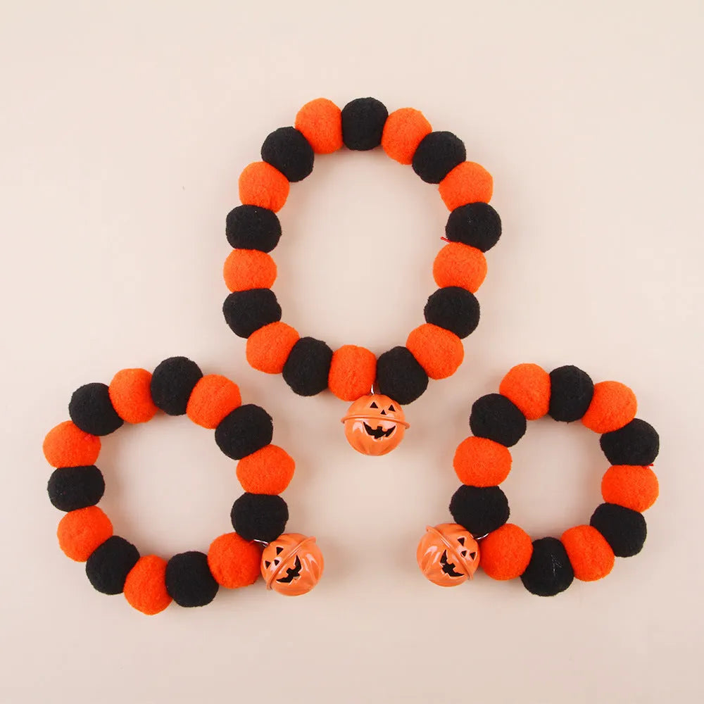 Black, orange, green, and purple Halloween pumpkin cat collar with adjustable strap.