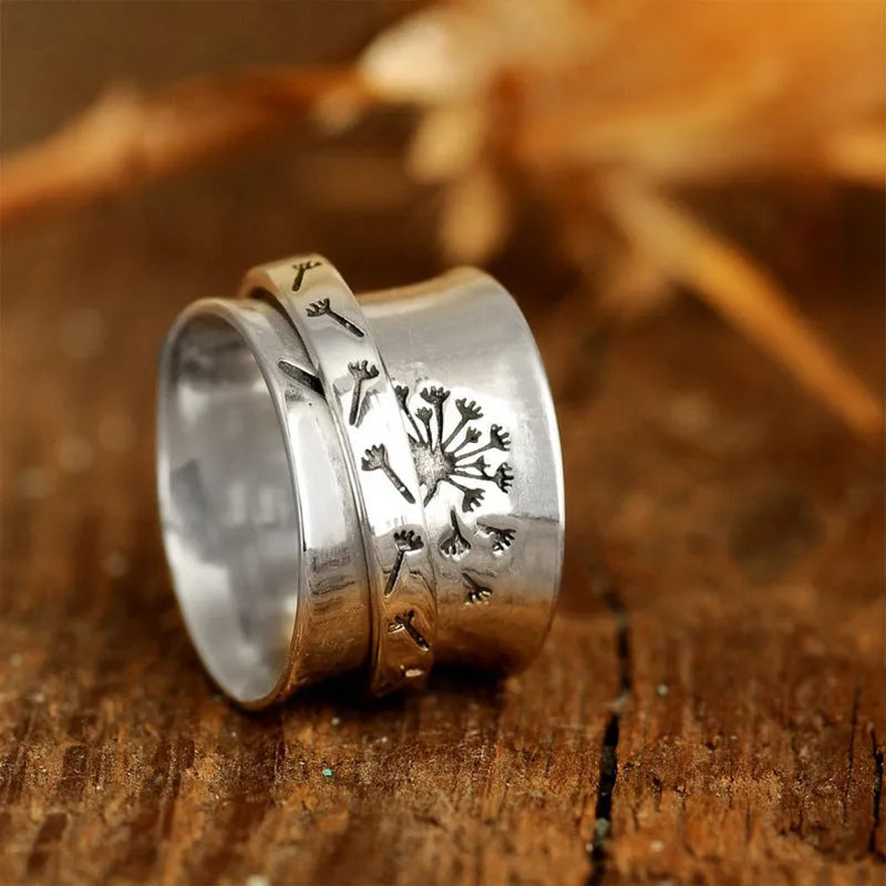 Silver rotatable flower ring showing spinning petals on alloy band