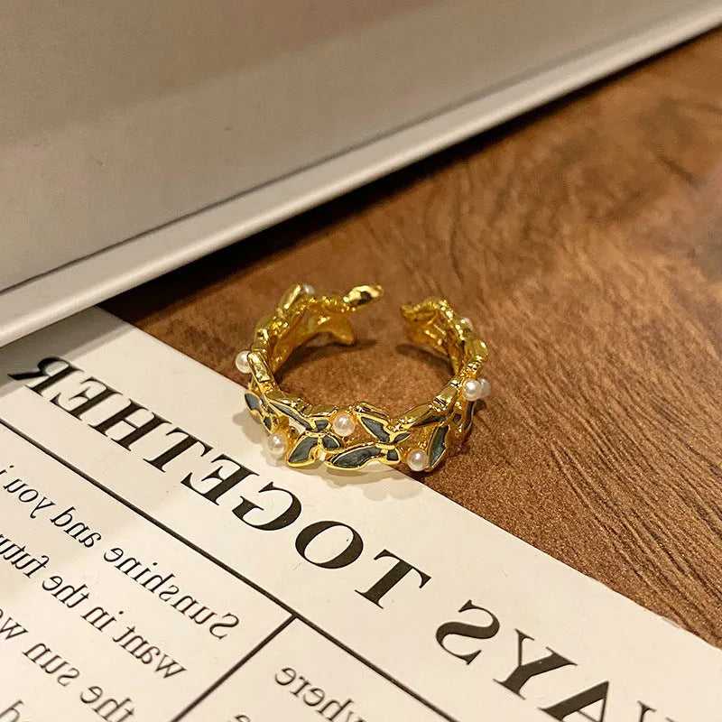 Copper butterfly women's ring with drip oil finish in an open-loop design.