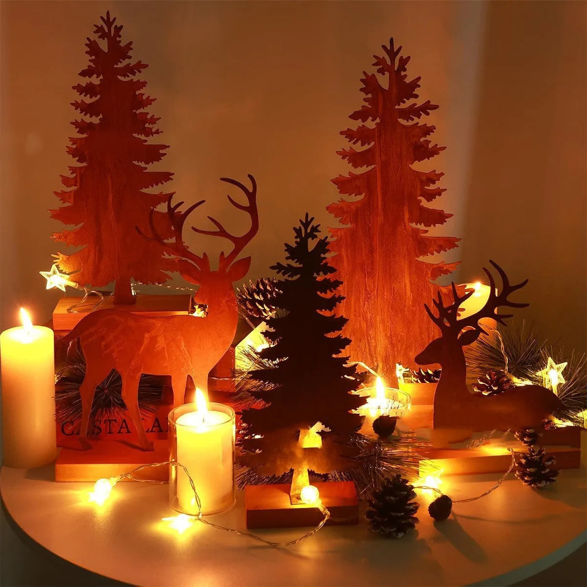 Three metal Christmas tree ornaments with elk silhouettes in rusty iron finish