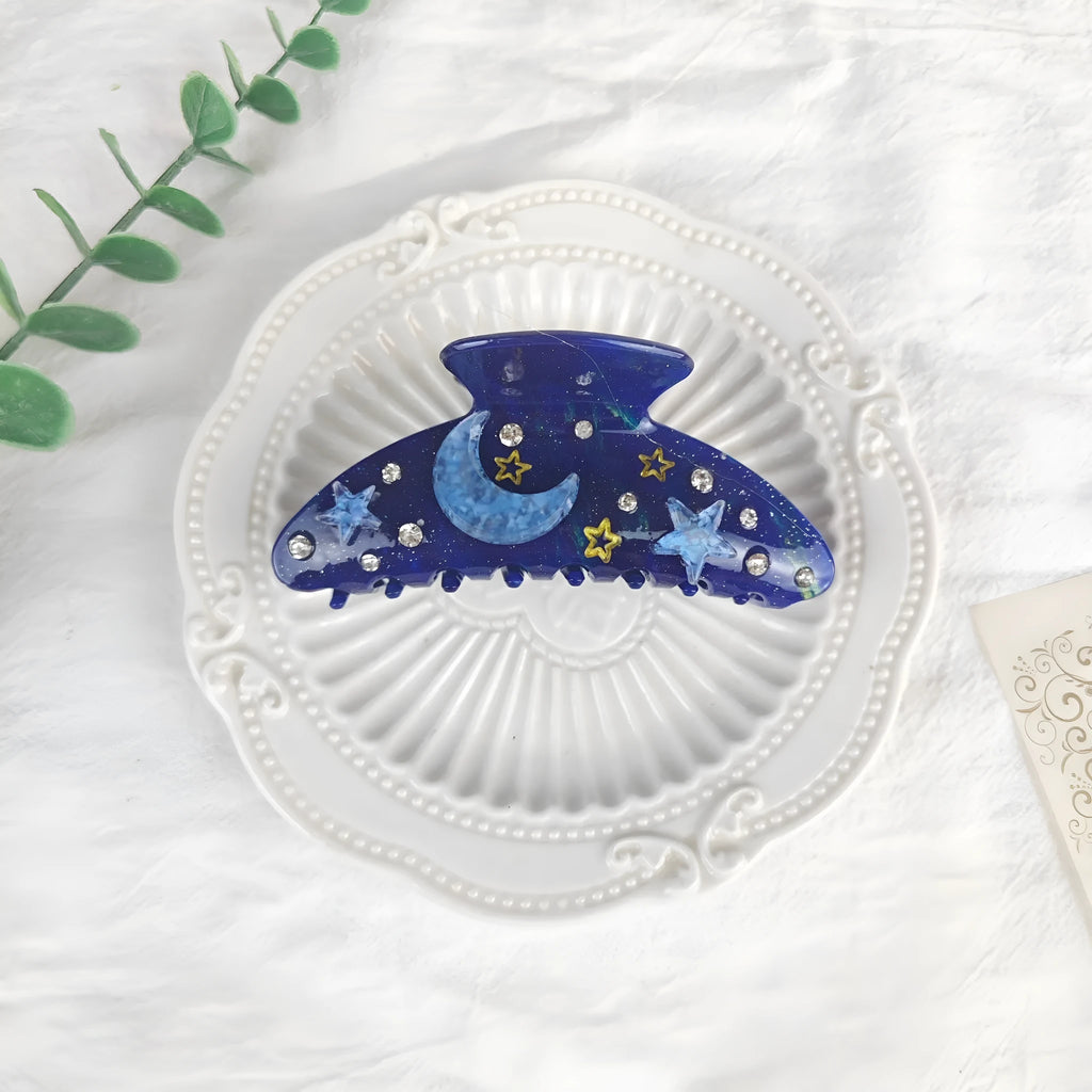 Oversized starry sky pattern hair barrette in cellulose acetate, shown in a choice of colours.