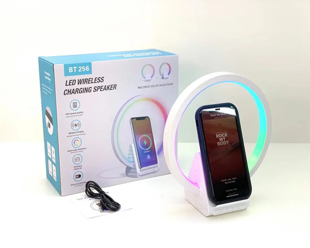 White rectangular smart Bluetooth speaker with integrated wireless charging pad and ambient lighting