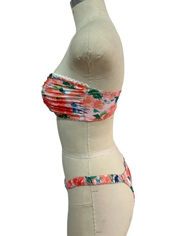 Women's floral print polyester bikini set in blue on a mannequin, showing tube top and briefs.