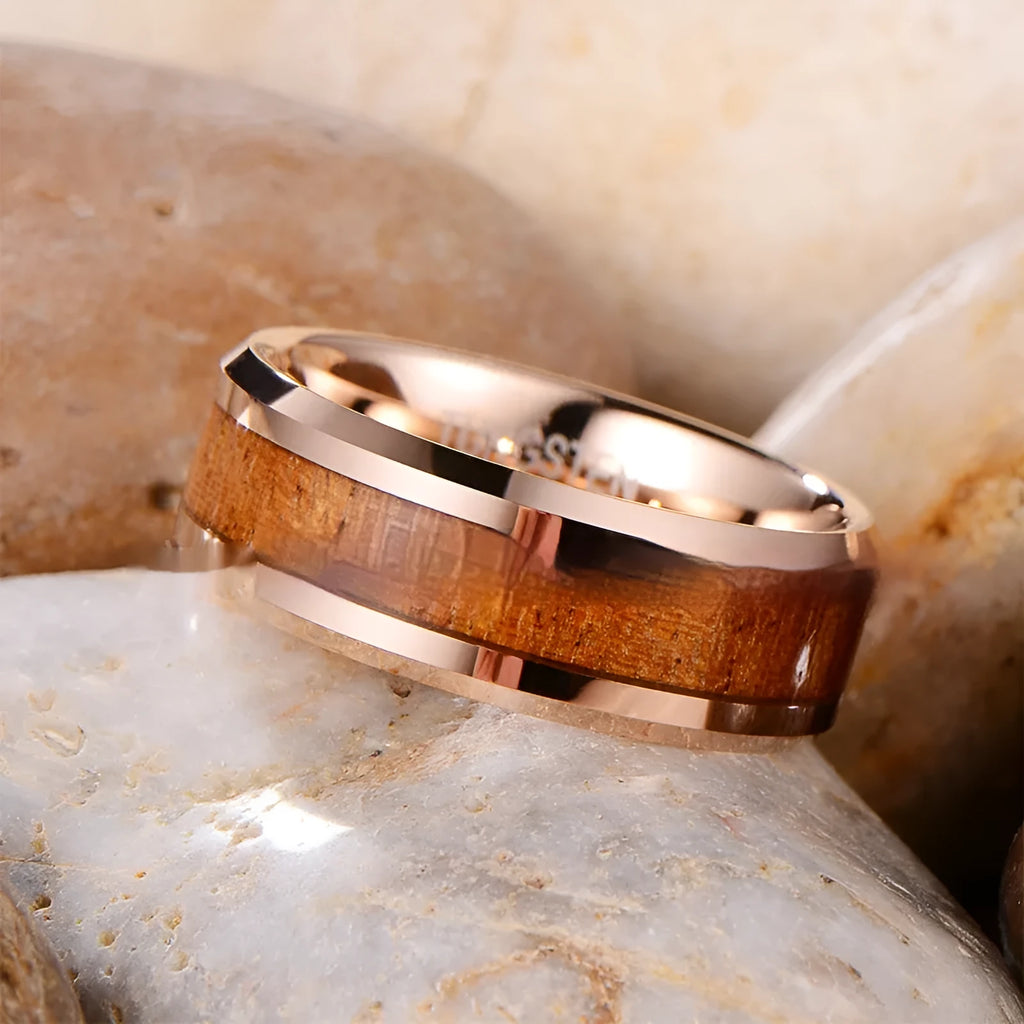 8mm wide U-shaped Ugyen men's ring in rose gold or steel colour on a plain background.